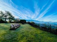 a row of chairs sitting on the grass near a fence at Junyi Landscape Villa in Ren&#39;ai