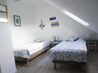 a bedroom with two beds and two tables at Maison Le Tour-du-Parc, 4 pièces, 6 personnes - FR-1-639-51 in Le Tour-du-Parc