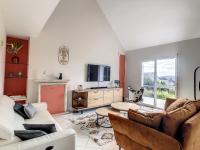 a living room with a couch and a tv at Maison Crozon, 5 pièces, 8 personnes - FR-1-370-81 in Crozon