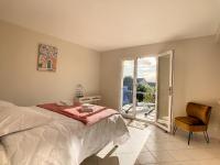 a bedroom with a bed and a chair and a window at Maison Crozon, 5 pièces, 8 personnes - FR-1-370-81 in Crozon