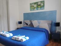 a bedroom with a blue bed with towels on it at Brà Guest House in Verona