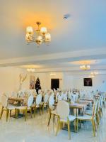a banquet hall with tables and chairs and a christmas tree at Cerbul Chalét Accommodation & Wellness in Râşnov