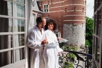 a man and a woman standing on a balcony at Van Der Valk Sélys Liège Hotel &amp; Spa in Liège