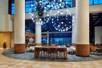 a dining hall with tables and chairs and a chandelier at Orlando World Center Marriott in Orlando