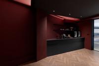 a kitchen with red walls and a black counter at 山久蒔x勺光 in Yuchi