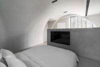 a white bedroom with a bed and a tv at 山久蒔x勺光 in Yuchi