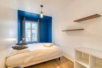 a bedroom with blue walls and a bed with pillows at L Axelle magnifique F4 plein centre de Rouen ! in Rouen