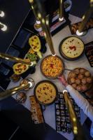 a table with many different types of food on it at Elexus Apartments Poiana Brasov in Poiana Brasov