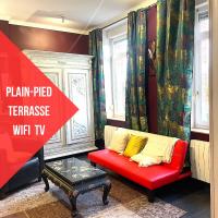 a red couch with yellow pillows in a living room at La Domus Lemaitre 1, plain-pied, Wifi , TV, parking, jardin 