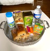 a tray with food and drinks on a table at La Domus Lemaitre 1, plain-pied, Wifi , TV, parking, jardin 