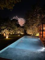 a swimming pool with fireworks in the background at night at Un paradis avec piscine au cœur du village in Cassis