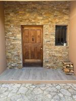 a wooden door on a brick building with a stone wall at Un paradis avec piscine au cœur du village in Cassis