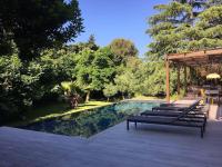 a swimming pool with a deck and a patio at Un paradis avec piscine au cœur du village in Cassis