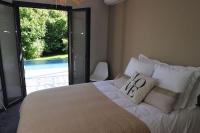 a bedroom with a bed with a view of a pool at Un paradis avec piscine au cœur du village in Cassis