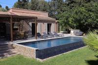 a swimming pool with lounge chairs next to a house at Un paradis avec piscine au cœur du village in Cassis