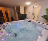 a jacuzzi tub in a living room at La marine D&#39;opale in Ambleteuse