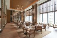 東京にあるThe Okura Tokyo（オークラ東京）のテーブルと椅子と大きな窓のあるレストラン