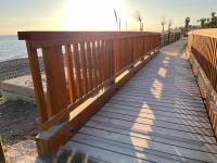 a wooden boardwalk leading to the beach at Casa Las Toro Playa in Chilches