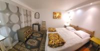 a small bedroom with two beds and a television at Les Nympheas, appart, grand jardin au calme, parking gratuit,15 min Disneyland, in Crécy-la-Chapelle