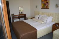 A bed or beds in a room at Sunshine Pearl Family Hotel