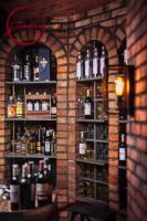 a room with shelves filled with bottles of alcohol at Hotel Cristal Park in Tarnów