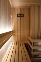 an empty sauna with a bench in the corner at Atypik Hotel in Clichy