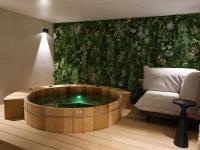 a living room with a large wooden tub with a chair at Atypik Hotel in Clichy