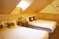 two beds in a room with a attic at Fennel Resort in Checheng