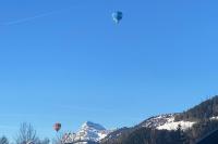 a hot air balloon flying over a snowy mountain at Family cocoon Prime Rochebrune location in Megève