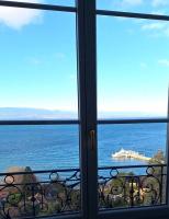 a view of the ocean from a window at Appartement avec vue 180 sur le Lac Léman in Thonon-les-Bains