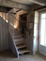 a set of stairs in a room with a door at Maison d hôtes Les Chantours dans réserve naturelle 15 hectares in Saint-Antoine-Cumond
