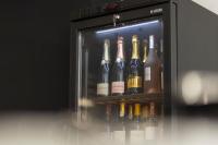 un refrigerador lleno de muchas botellas de vino en Destiny Hotel & SPA, en Tirana