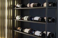 un montón de botellas de vino en una bodega en Destiny Hotel & SPA, en Tirana