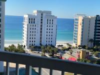 ein Blick auf den Strand vom Balkon eines Gebäudes in der Unterkunft St Lucia 1204 a Luxury Condo with Gulf Views in Destin