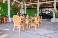 a wooden table and chairs in a restaurant at Nawa Wellness in Calatagan