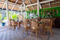 a dining room with wooden tables and chairs at Nawa Wellness in Calatagan