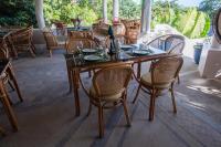 a wooden table and chairs on a patio at Nawa Wellness in Calatagan