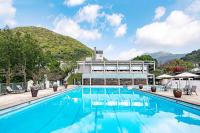 a pool at a hotel with a mountain in the background at CHECK inn Select Taipei Yamgmingshan in Taipei