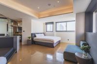 a bedroom with a bed and a couch at CHECK inn Taichung Liming in Taichung