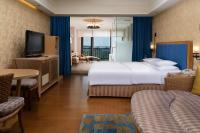 a hotel room with a large bed and a television at E-DA Royal Hotel in Dashu
