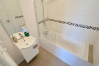a white bathroom with a sink and a shower at Loft en duplex atypique 4ch + parking in Tourcoing