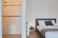 a bedroom with a bed and a bath tub next to a bed at Loft en duplex atypique 4ch + parking in Tourcoing