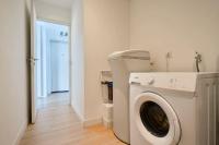 a white washing machine in a room with a hallway at Loft en duplex atypique 4ch + parking in Tourcoing