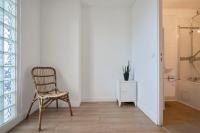 a chair in a room with a white wall at Loft en duplex atypique 4ch + parking in Tourcoing