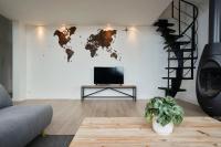 a living room with a tv and a world map on the wall at Loft en duplex atypique 4ch + parking in Tourcoing