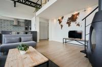 a living room with a couch and a table at Loft en duplex atypique 4ch + parking in Tourcoing