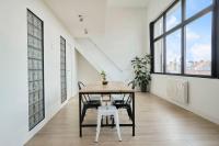 a dining room with a table and chairs at Loft en duplex atypique 4ch + parking in Tourcoing