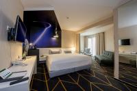a hotel room with a bed and a couch at Science Hotel in Szeged