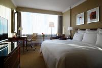 a hotel room with a large bed and a desk at Warsaw Presidential Hotel in Warsaw