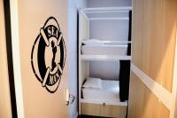 a room with a closet with two beds at Gspot Hostels & Love Triangles Pizzeria in Lisbon